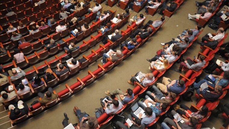 Personen sitzen in einem Hörsaal